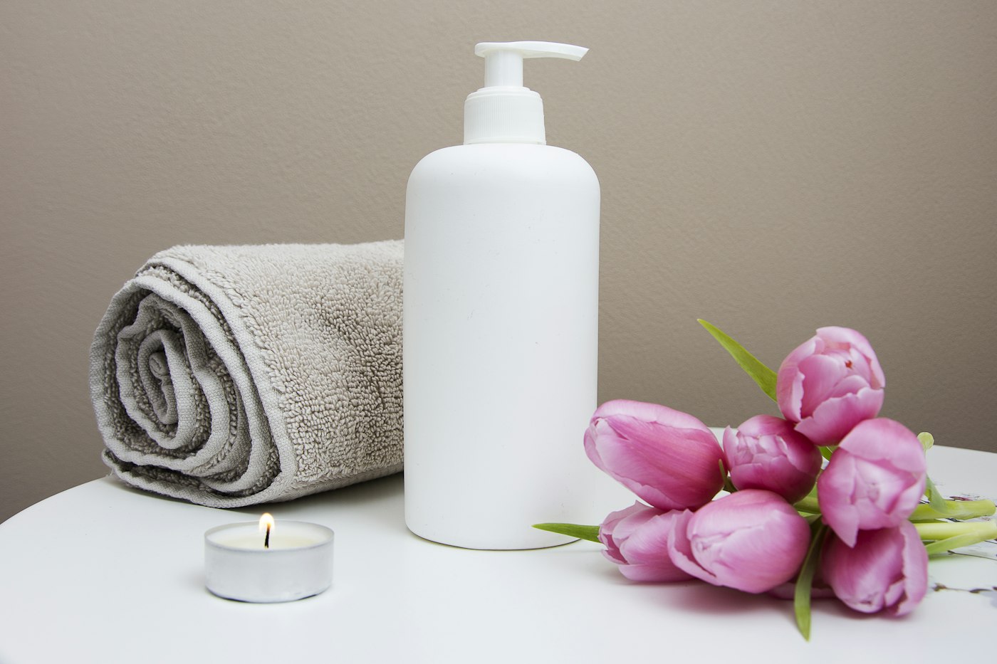 Gilbert Healing Massage reviews – rolled towel, massage lotion and fresh tulips