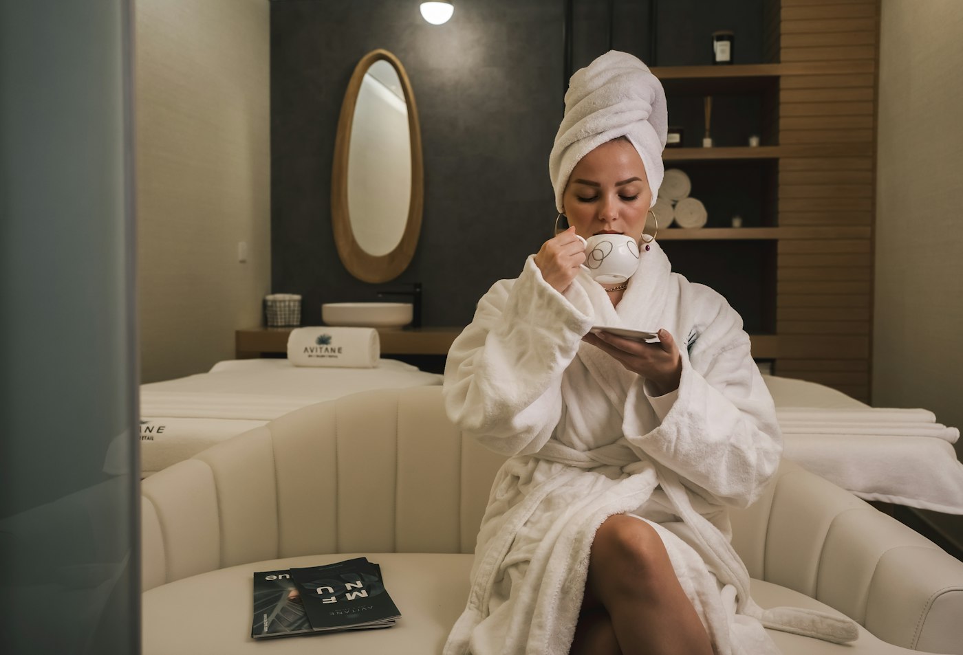Massage prices in Gilbert, AZ – client in a robe enjoying tea after her massage