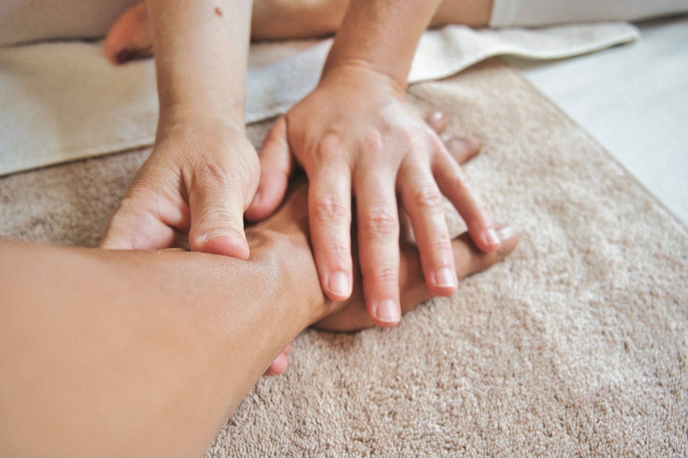 Massage prices in Gilbert, AZ – hands massaging a client’s wrist and forearm